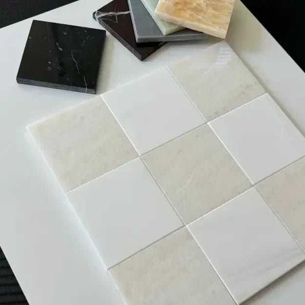 Close-up of checkerboard marble tiles in various colors on a white surface