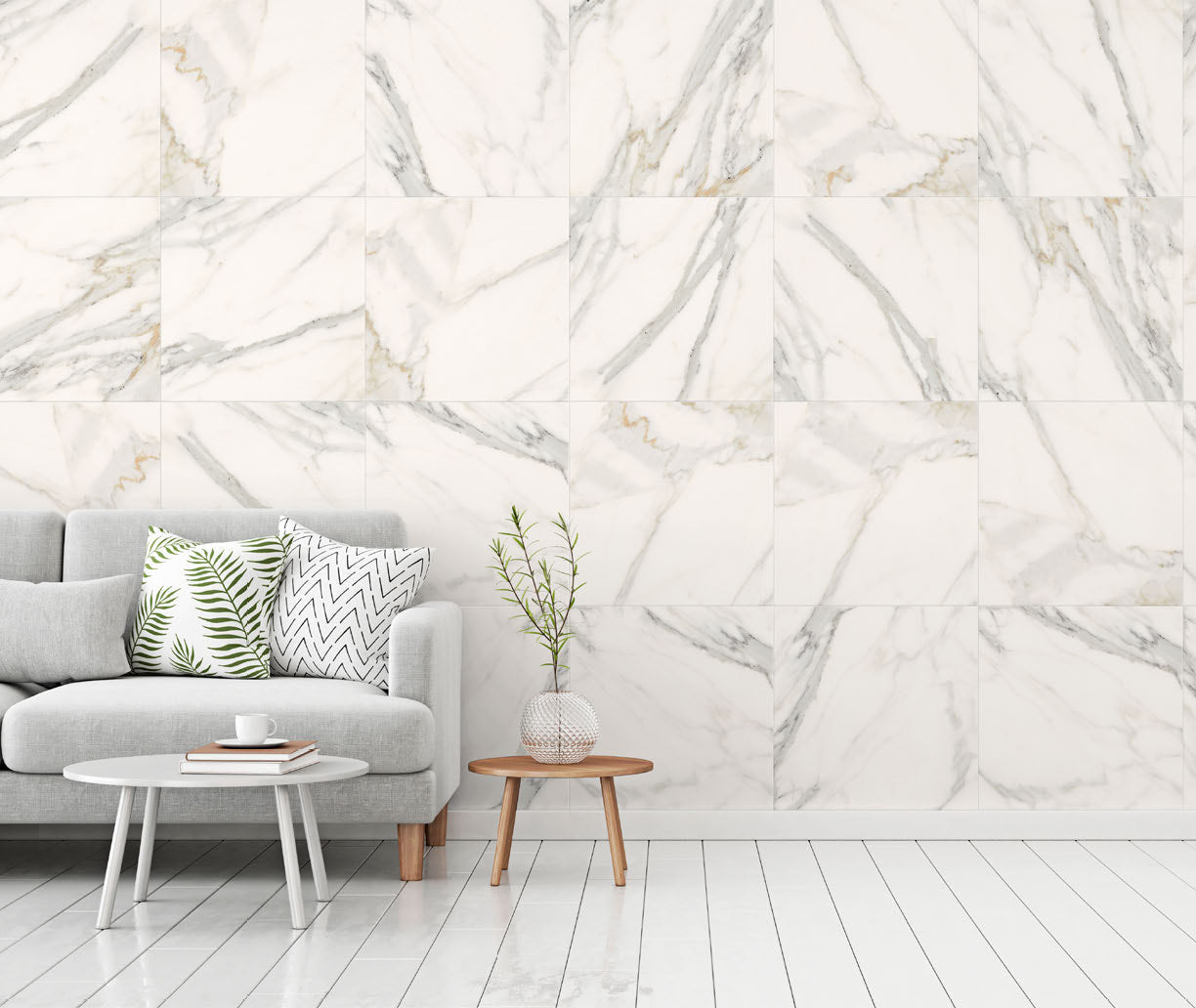 Aria Calacatta Gold marble bathroom with 24x24 wall and bold veining