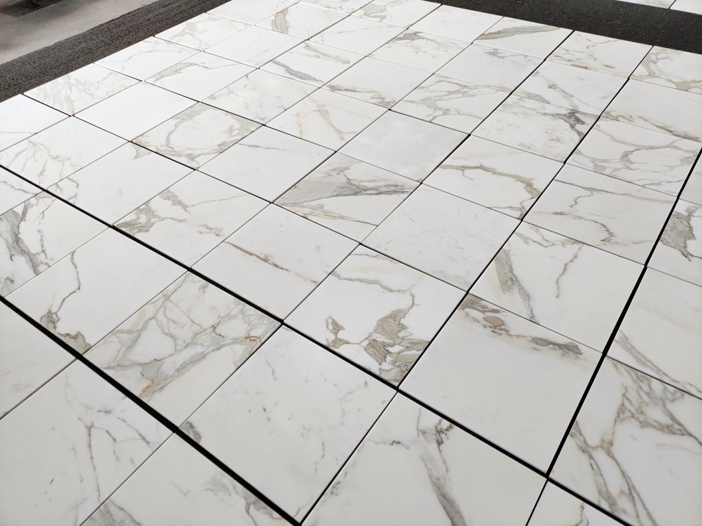 Aria calacatta gold 18x18 Marble-patterned tiles on a floor