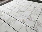 Aria calacatta gold 18x18 Marble-patterned tiles on a floor