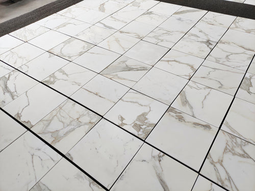 Aria calacatta gold 18x18 Marble-patterned tiles on a floor
