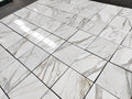 Italian Calacatta Gold marble tile 18x18 polished, dry layout showing veining variation across multiple tiles.
