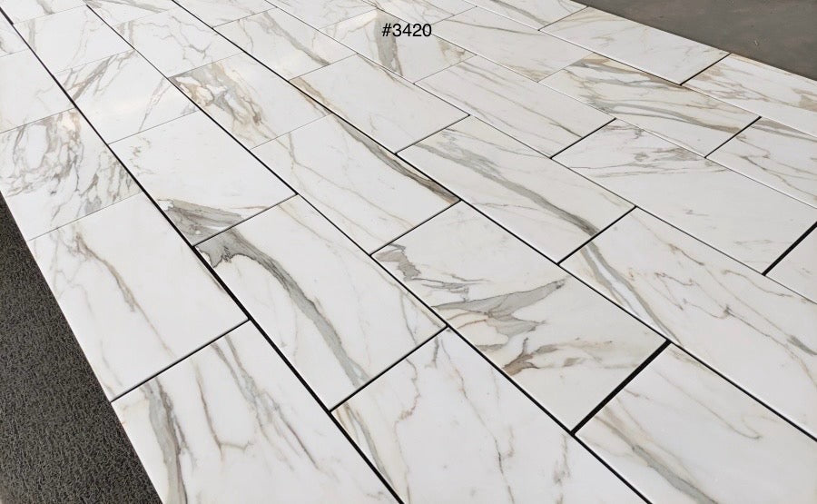 Calacatta Gold Italian Marble-12x24 patterned tiles on a floor