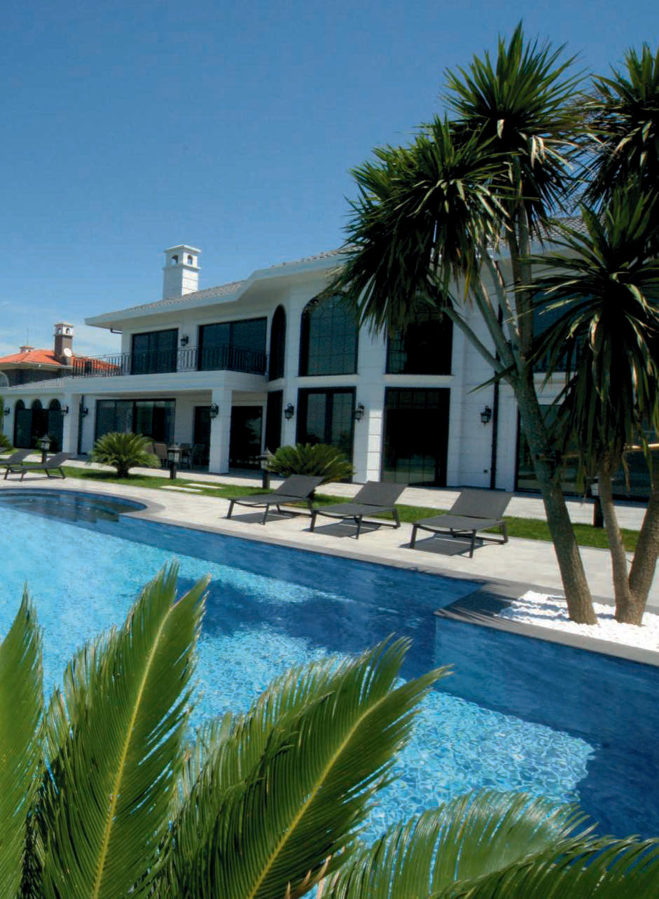 Outdoor pool built by Artepierre's relax collection surrounded by luxury estate scene.