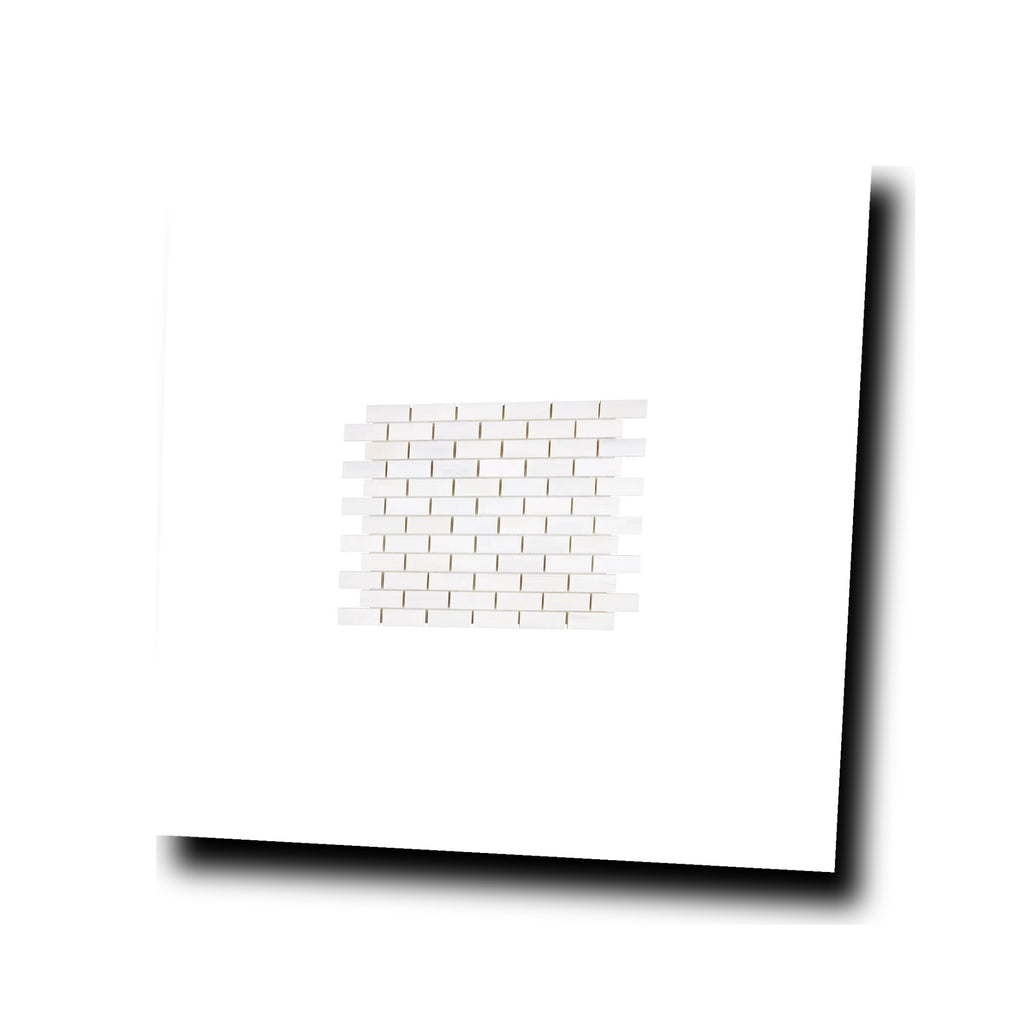 Angled view of Aria Bianco Dolomite 1x2 brick marble mosaic sheet highlighting surface character and subtle veining.