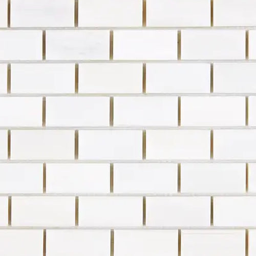 Close-up of Bianco Dolomite 1x2 brick marble mosaic showing tile edges, spacing, and natural stone variation across pieces.