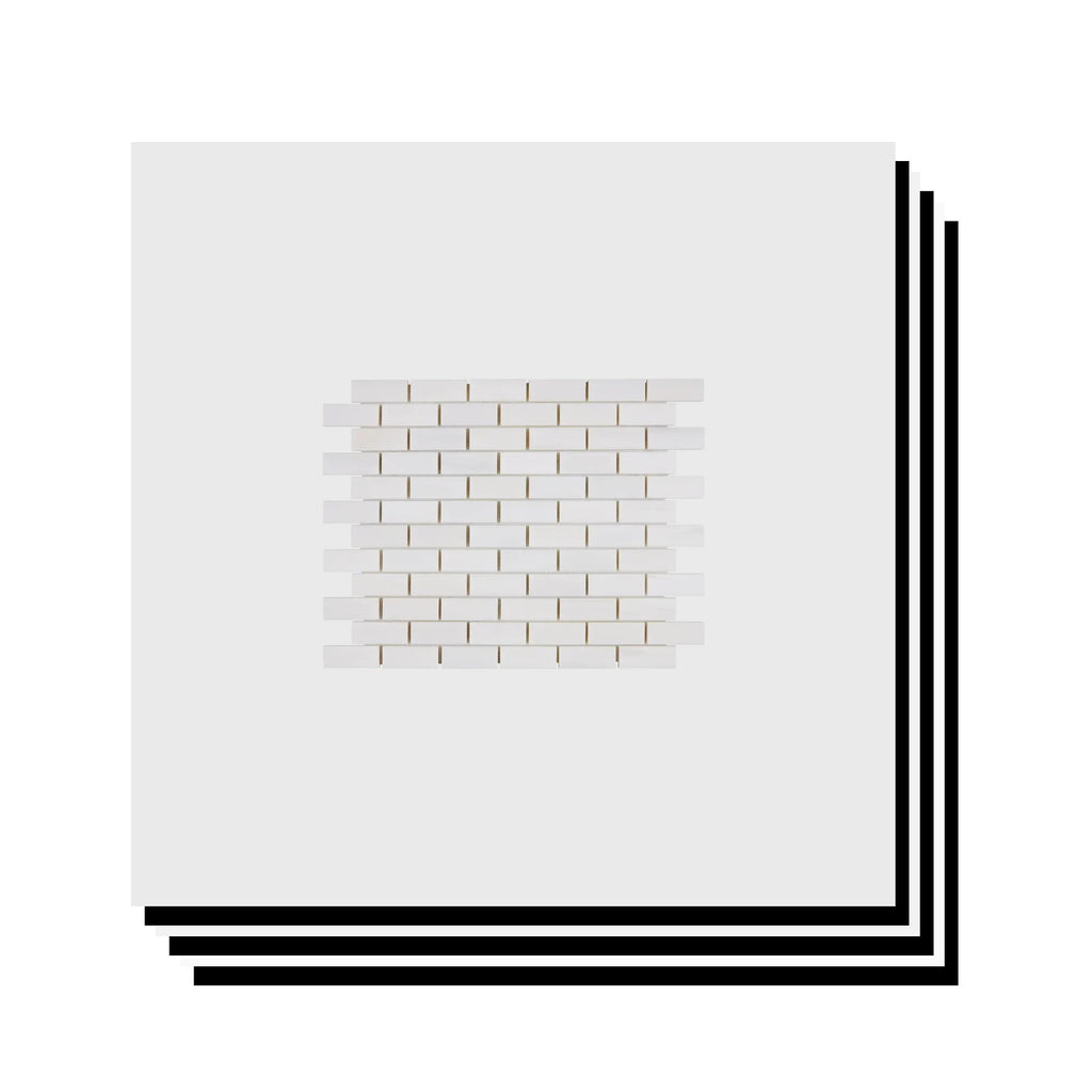 Stacked Aria Bianco Dolomite 1x2 brick marble mosaic sheets showing consistent color range and natural variation.
