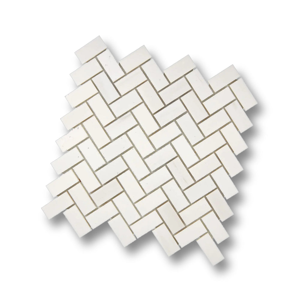 Angled view of Aria Bianco Dolomite 1x2 herringbone mosaic sheet highlighting the pattern and soft natural veining.