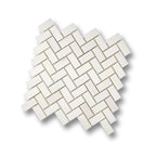 Angled view of Aria Bianco Dolomite 1x2 herringbone mosaic sheet highlighting the pattern and soft natural veining.