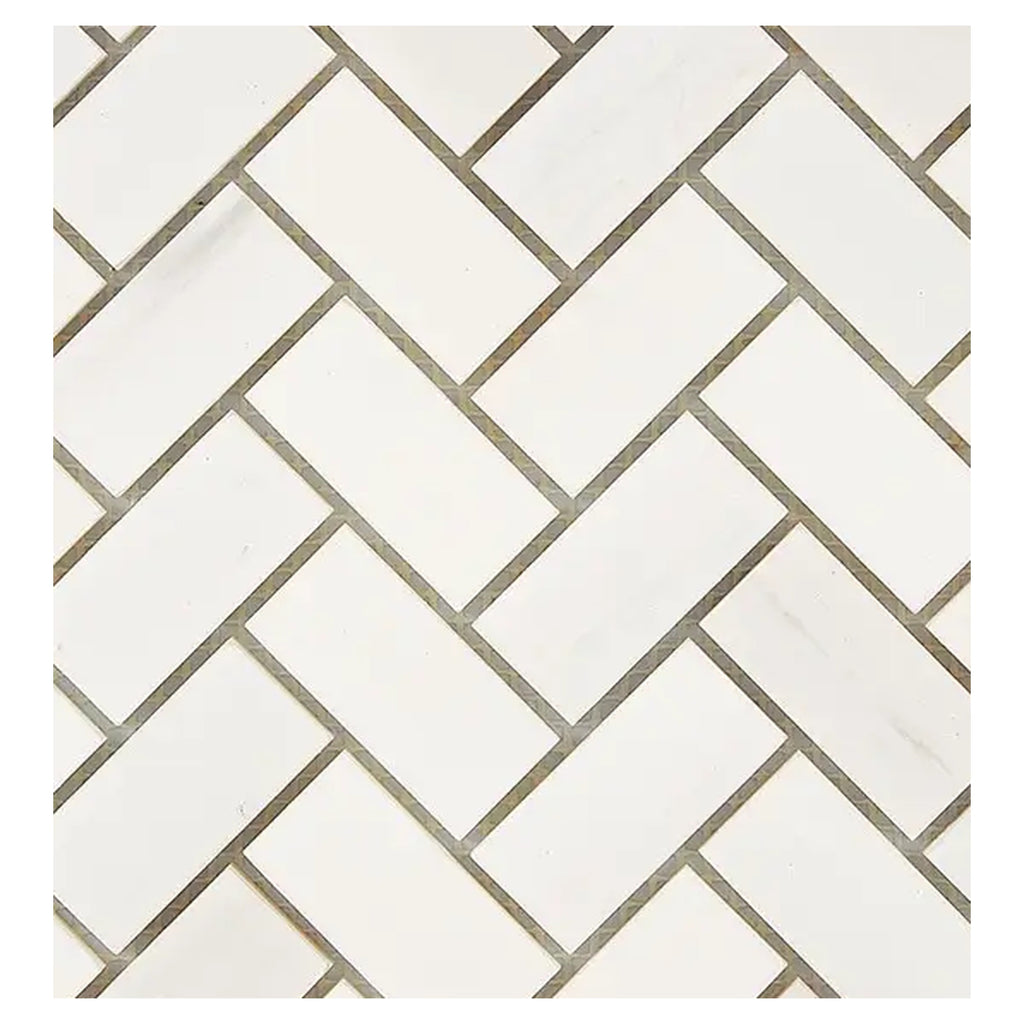 Close-up of Bianco Dolomite 1x2 herringbone marble mosaic showing tile edges, spacing, and natural stone variation.