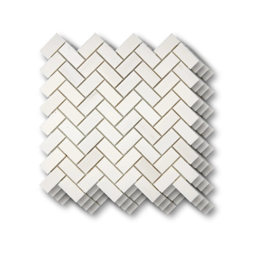 Stacked Aria Bianco Dolomite 1x2 herringbone marble mosaic sheets showing consistent color range and natural variation.