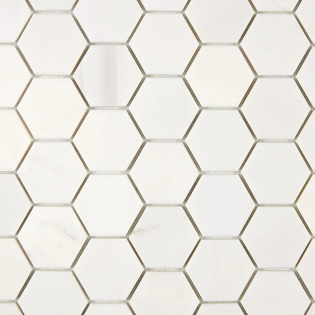 Close-up of Bianco Dolomite 2-inch hexagon marble mosaic showing tile edges, spacing, and natural stone variation.
