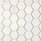 Close-up of Bianco Dolomite 2-inch hexagon marble mosaic showing tile edges, spacing, and natural stone variation.
