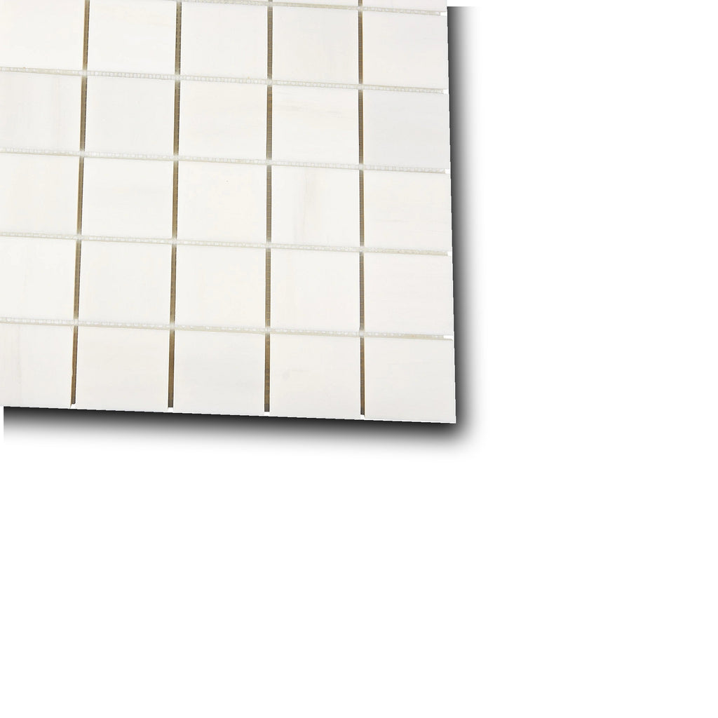 Angled view of Aria Bianco Dolomite 2x2 marble mosaic sheet highlighting surface character and subtle veining.