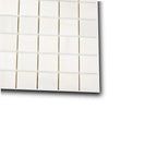 Angled view of Aria Bianco Dolomite 2x2 marble mosaic sheet highlighting surface character and subtle veining.