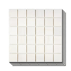 Stacked Aria Bianco Dolomite 2x2 marble mosaic sheets showing consistent color range and natural variation across pieces.