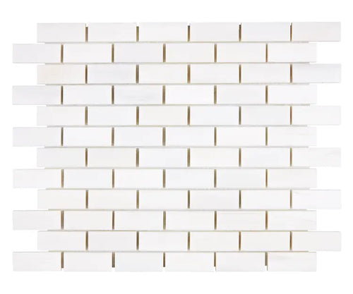 Aria Bianco Dolomite marble mosaic 1x2 brick, studio image of a mounted sheet showing subtle natural veining and soft tone variation.