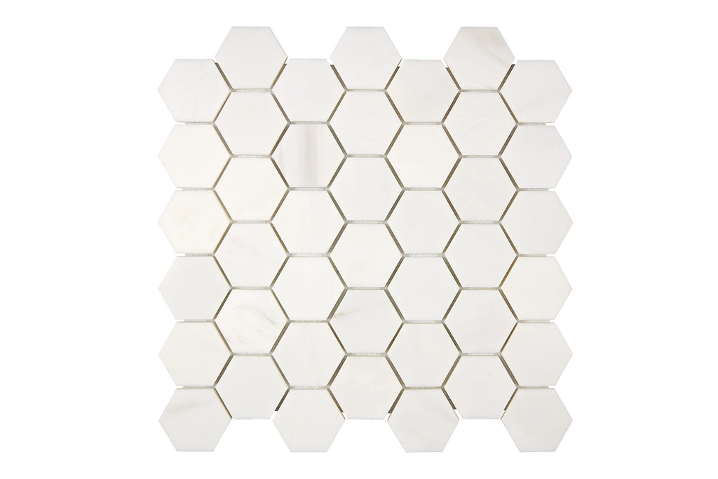 Aria Bianco Dolomite marble mosaic 2-inch hexagon, studio image of a mounted sheet showing subtle natural veining and soft tone variation.