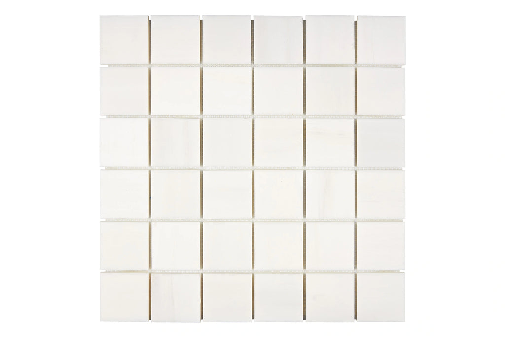 Aria Bianco Dolomite marble mosaic 2x2, studio image of a mounted sheet showing subtle natural veining and soft tone variation.