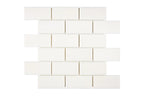 Aria Bianco Dolomite marble mosaic 2x4 brick, studio image of a mounted sheet showing subtle natural veining and soft tone variation.