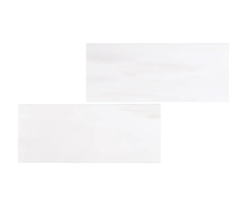 Aria Bianco Dolomite marble subway tile 3x6, studio image showing a soft white background with subtle natural veining and gentle tone variation.

