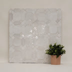 Gallery zellige mosaic display board in glossy white showing octagon-and-cross pattern with handmade variation (Heritage)