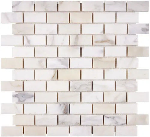 Aria Calacatta Gold marble 1x2 brick mosaic sheet, studio image showing a bright white background with warm gold veining and subtle gray movement across the mounted pattern.