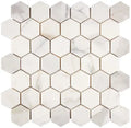 Aria Calacatta Gold marble 2-inch hexagon mosaic sheet, studio image showing a bright white background with warm gold veining and subtle gray movement across the mounted pattern.
