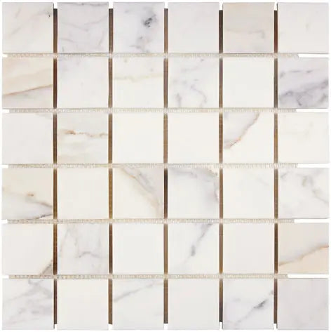 Aria Calacatta Gold marble 2x2 mosaic sheet, studio image showing a bright white background with warm gold veining and subtle gray movement across the mounted grid.