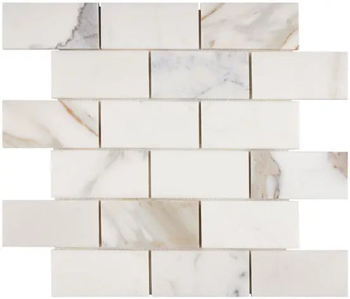 Aria Calacatta Gold marble 2x4 brick mosaic sheet, studio image showing a bright white background with warm gold veining and subtle gray movement across the mounted pattern.
