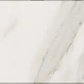 Aria Calacatta Gold marble tile 4x4, studio image showing a bright white background with warm gold veining and soft gray movement with natural variation.
