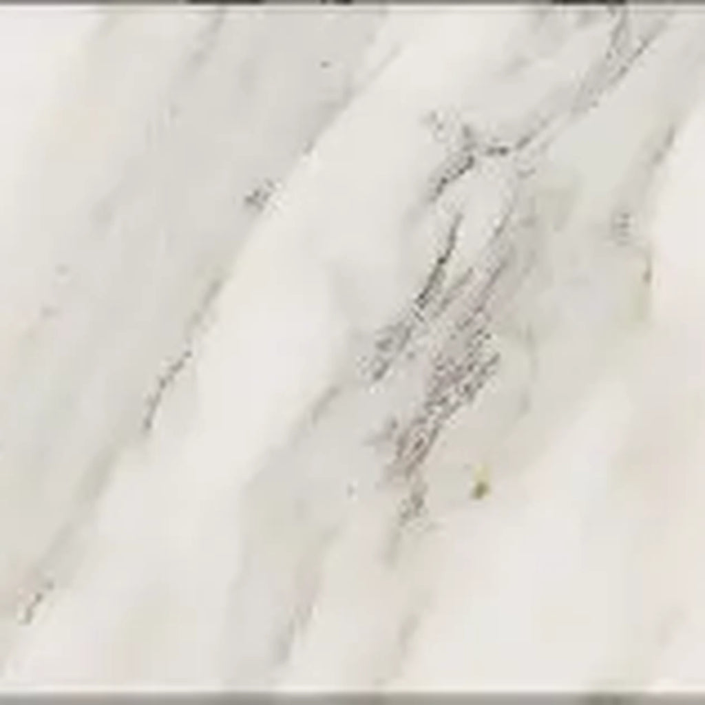 Close-up of a Calacatta Gold 4x4 marble surface with gray and white patterns.