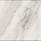 Close-up of a Calacatta Gold 4x4 marble surface with gray and white patterns.