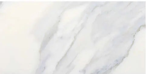 Aria Calacatta Gold marble subway tile 6x12, studio image showing a bright white background with warm gold veining and soft gray movement with natural variation.
