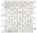 Aria Carrara White marble 1x2 brick mosaic sheet, studio image showing bright white stone with soft gray veining and natural variation in a clean running-bond layout.