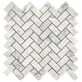 Aria Carrara White marble 1x2 herringbone mosaic sheet, studio image showing bright white stone with soft gray veining and natural variation in a classic herringbone pattern.