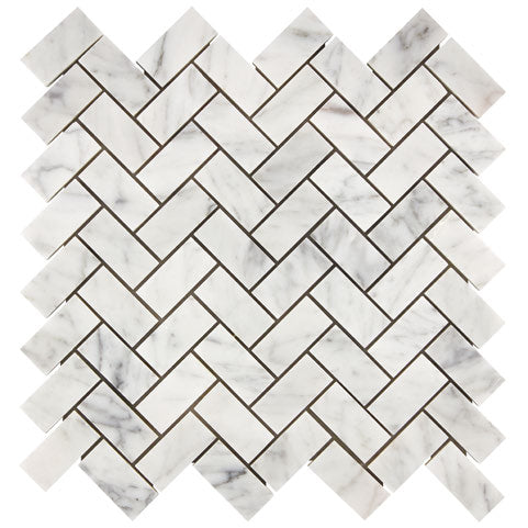 Aria Carrara White marble 1x2 herringbone mosaic sheet, studio image showing bright white stone with soft gray veining and natural variation in a classic herringbone pattern.