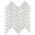 Aria Carrara White marble 1x4 herringbone mosaic sheet, studio image showing bright white stone with soft gray veining and natural variation in a classic herringbone pattern.