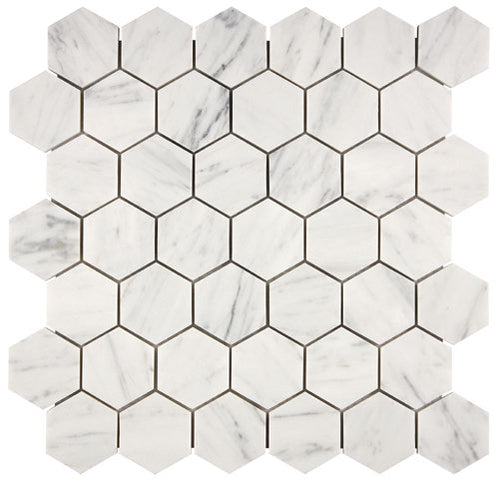 Aria Carrara White marble 2-inch hexagon mosaic sheet, studio image showing bright white stone with soft gray veining and natural variation across the mounted hex pattern.
