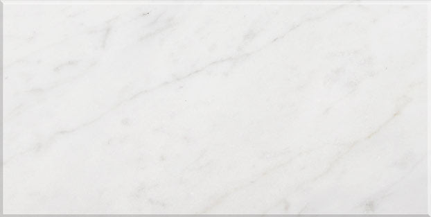 Aria Carrara White marble tile 12x24, studio image showing a bright white base with soft gray veining and natural variation for timeless shower walls, classic floors, and elegant backsplashes.