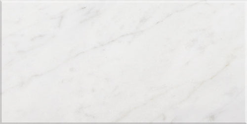 Aria Carrara White marble tile 12x24, studio image showing a bright white base with soft gray veining and natural variation for timeless shower walls, classic floors, and elegant backsplashes.