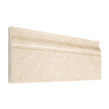 Aria Crema Marfil marble baseboard trim, studio image showing a molded warm beige marble profile with gentle movement for soft wall-to-floor transitions.
