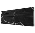 Aria Nero Marquina black marble baseboard trim, studio image showing a molded deep-black marble profile with bold white veining for high-contrast wall-to-floor transitions.