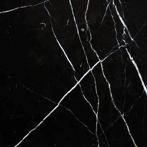 Aria Nero Marquina black marble tile 12x12, studio image showing deep black stone with bold white veining and natural high-contrast variation for dramatic walls, floors, and graphic accents.