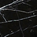 Aria Nero Marquina black marble tile 18x18, studio image showing deep black stone with bold white veining and natural high-contrast variation for dramatic floors, feature walls, and statement spaces.