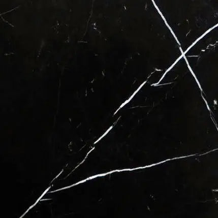 Aria Nero Marquina black marble tile 24x24, studio image showing deep black stone with bold white veining and natural high-contrast variation for dramatic floors, feature walls, and statement spaces.