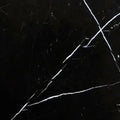 Aria Nero Marquina black marble tile 24x24, studio image showing deep black stone with bold white veining and natural high-contrast variation for dramatic floors, feature walls, and statement spaces.