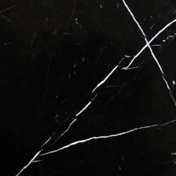 Aria Nero Marquina black marble tile 24x24, studio image showing deep black stone with bold white veining and natural high-contrast variation for dramatic floors, feature walls, and statement spaces.