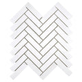 Aria Thassos White marble 1x4 herringbone mosaic sheet, studio image showing crisp bright-white pieces with minimal movement in a clean herringbone pattern for shower floors, niches, and accents.