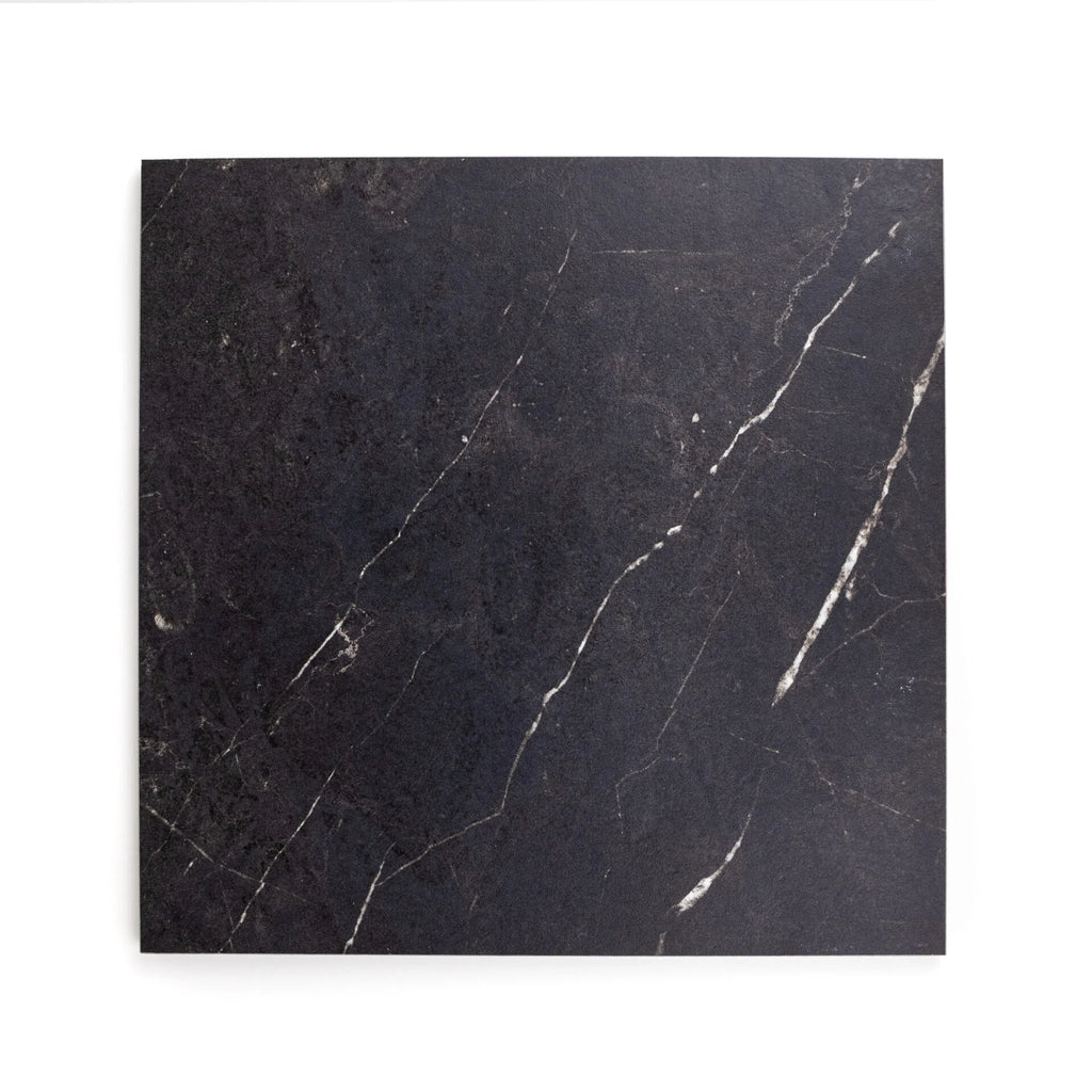 Black marble look alike porcelain tile with veins on a white background